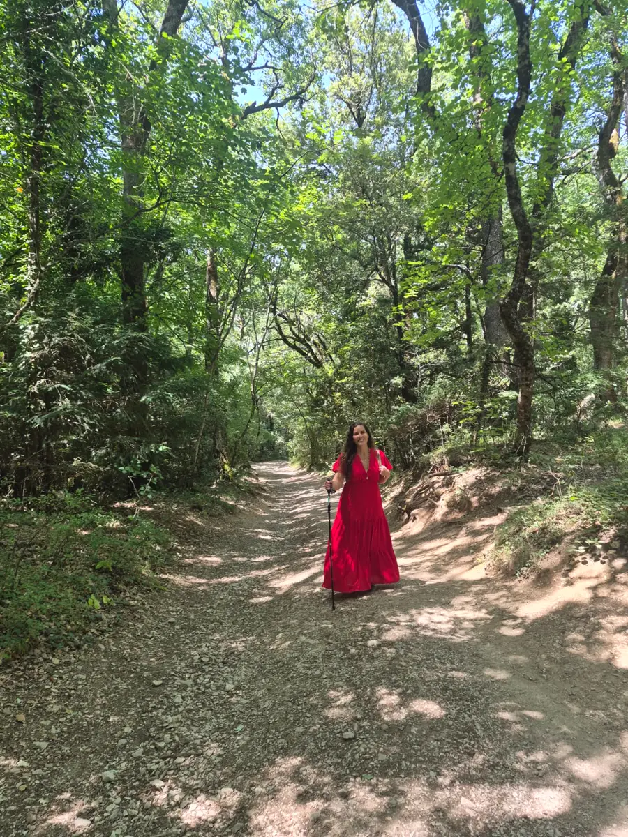 Hérica caminhando por uma trilha na floresta